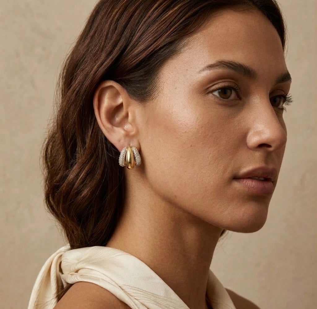 Two-tone gold and diamond pave triple hoop earring model lifestyle on face view.