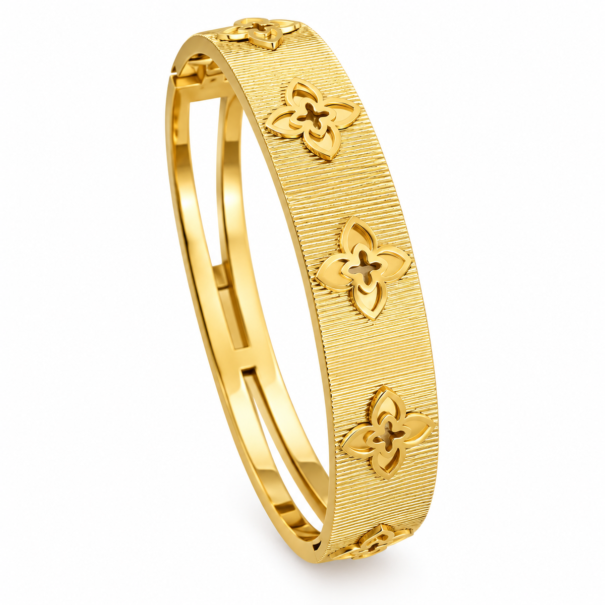 Gold textured floral clover bangle bracelet cut out motif hinged cuff jewelry on white background.