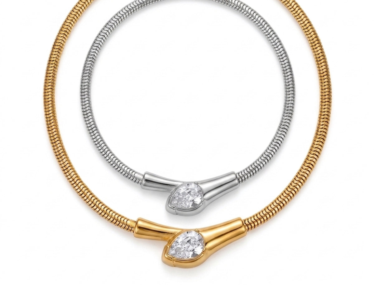 Gold and silver flexible snake chain collar necklaces featuring a teardrop-shaped bezel-set cubic zirconia centerpiece.